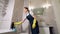 Girl puts a cleaner on the toilet. Hands in yellow rubber gloves for cleaning.