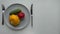 girl puts patisson vegetables, cucumber and tomato on a plate