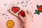 Girl putting red hearts on beige phone case