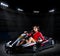 Girl racer with kart at stadium