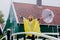 Girl in rain suit with umbrella stay on bridge with dutch house