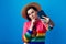 Girl in rainbow sweater holds finger on cheek, use mobile for making selfie