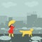 A girl in rainy autumn weather walks her Labrador dog