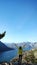 Girl with raised arms happy journey. Admiring the Boka Bay in Montenegro. Vertical view