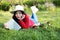 Girl reading the book. Blonde beautiful young woman with book lying on the grass. Outdoor. Sunny day