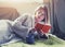 Girl reading book with coffee lying in bed