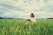 Girl reading a book on summer wildflower meadow