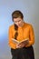 A girl reads the Bible while sitting on a chair on a blue background. The inscription in Russian -