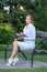 Girl ready to write with notebook sitting in park