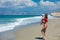 Girl in red bikini and baby on Tympaki beach