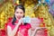 The girl in the red dress of Chinese descent is happy with red envelope with the dollar