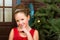 Girl in red dress welcomes New year and Christmas