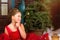 Girl in red dress welcomes New year and Christmas