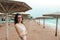 Girl in red glasses on the coast on a cloudy day Vacation by the sea. Summer, outdoors. Beach landscape