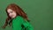 Girl red hair celebrating saint patrick`s day green wall background turning around