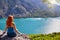 Girl with red hair on cliff top of canyon with green water