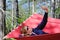 Girl in red hammock, woods