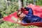 Girl in red hammock, woods