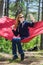 Girl in red hammock, woods