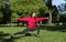 Girl in a red jacket engaged in sports, yoga in the Park in a clearing among the trees, the girl stands in the pose of a warrior