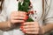 girl with red nails holding a green twig with berries in her hand