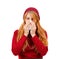 A girl in red sneezes and wipes her nose with her eyes ajar on a white isolated background