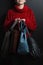 Girl in a red sweater holds leather handbags of different colors, women in a red sweater holds leather bags of different kinds, fo