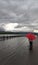 Girl with a red umbrella on a flooded embankment. Flood. Element.