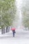 Girl with red umbrella in Snow Storm in April.