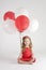 Girl with red and white balloons