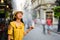 Girl refreshing in a water fan cooling on the street