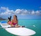 Girl relaxed lying on paddle surf board SUP