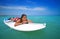 Girl relaxed lying on paddle surf board SUP