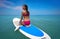 Girl relaxed on paddle surf board SUP