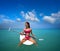 Girl relaxed sitting on paddle surf board SUP