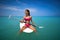 Girl relaxed sitting on paddle surf board SUP