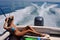 Girl relaxing on the back of motor boat