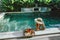 Girl relaxing and eating fruits in the pool on luxury villa in Bali