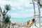 Girl relaxing in hammock in tropical beach cafe