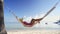 Girl relaxing in a hammock on tropical island beach. Summer vacation in Punta Cana, Dominican Republic