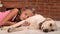 Girl relaxing with her labrador dog