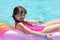 Girl relaxing on lilo in pool