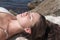 Girl relaxing on rocky beach