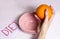 The girl reluctantly goes on a fruit diet, holding an orange over her pink plate