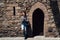 Girl relying on wall of ancient medieval castle