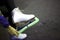 Girl removes  protective cover on white skate boot