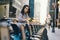 Girl renting a city bike from a bike stand