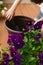 Girl replanting purple viola on the outdoor apartment balcony