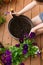 Girl replanting purple viola on the outdoor apartment balcony