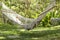 Girl resting in a cozy hammock in a tropical garden on the island of Bali, Indonesia